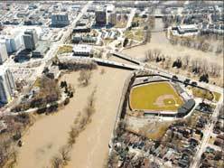 High water inundates low-lying areas near the forks of the Thames River in London in 2008. West London dike, opposite Harris Park, could be overtopped by "climate change-caused flooding," a report says. (Free Press file photo)